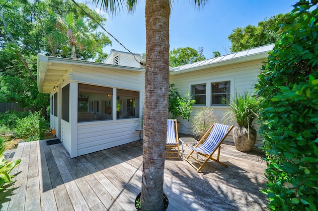 wooden terrace featuring a sunroom