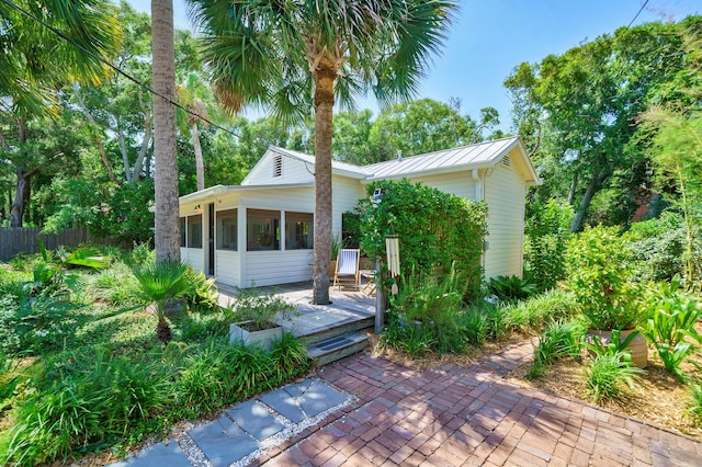 view of front of home featuring a patio area and a sunroom