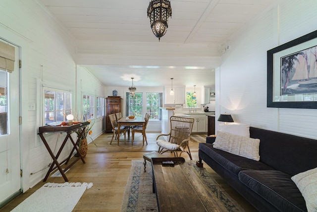 living room featuring light hardwood / wood-style floors and an inviting chandelier