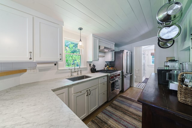 kitchen with white cabinets, decorative light fixtures, sink, and stainless steel appliances