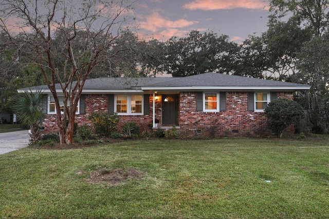 single story home with a front yard, crawl space, and brick siding