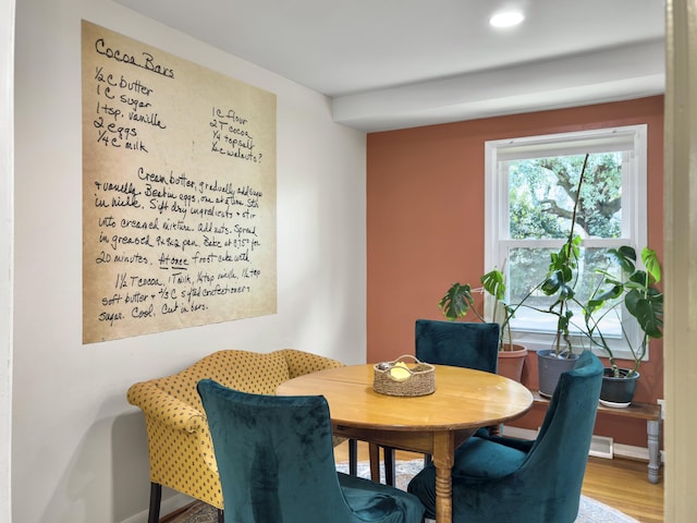 dining area featuring wood finished floors and visible vents