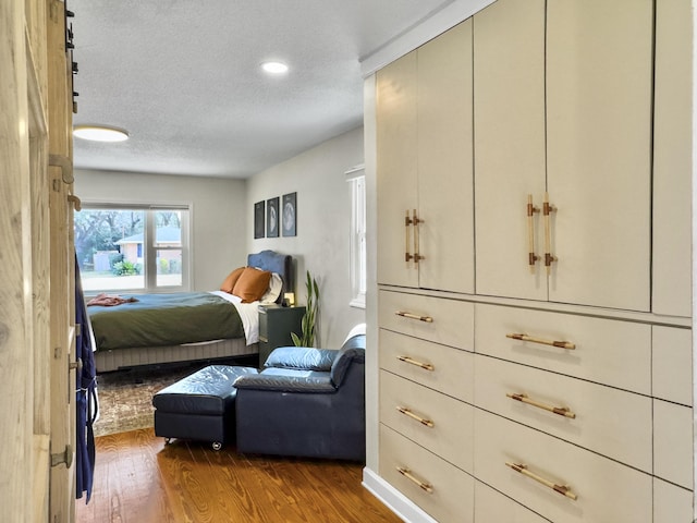 bedroom featuring a textured ceiling and dark wood-type flooring