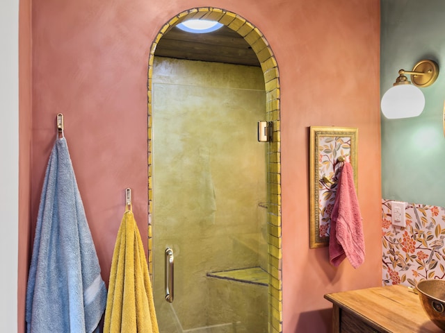 full bath with a shower stall and vanity