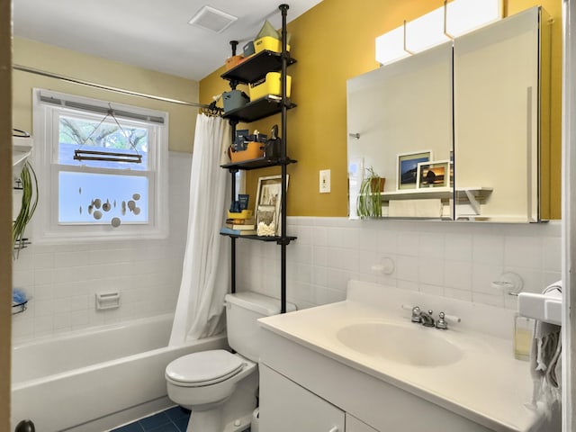 bathroom with tile walls, visible vents, toilet, shower / tub combo, and vanity