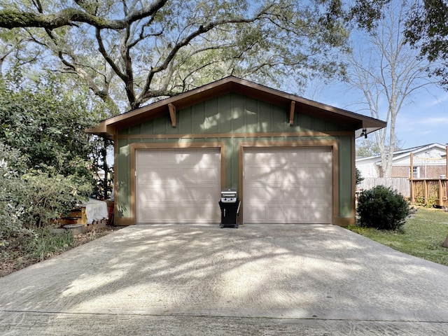 detached garage featuring fence