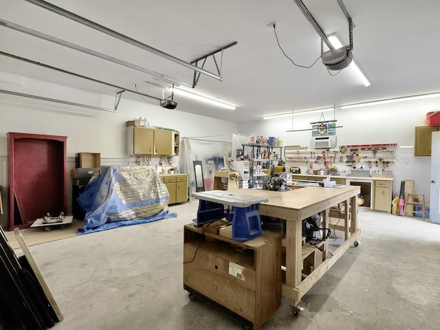 garage featuring a garage door opener and a workshop area