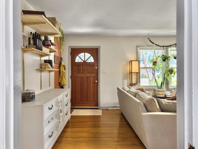 foyer entrance featuring light wood-style floors and visible vents