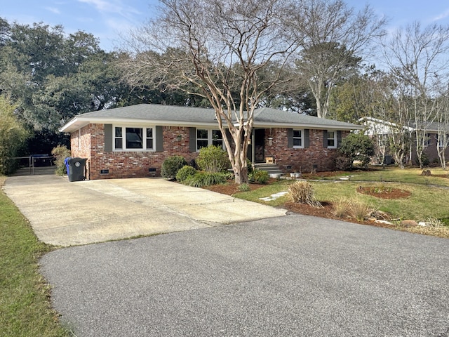 ranch-style home with crawl space, driveway, a front yard, and brick siding