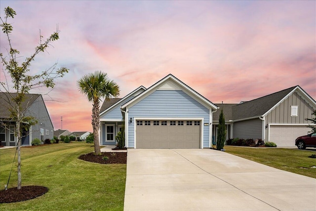 view of front of house with a garage and a lawn