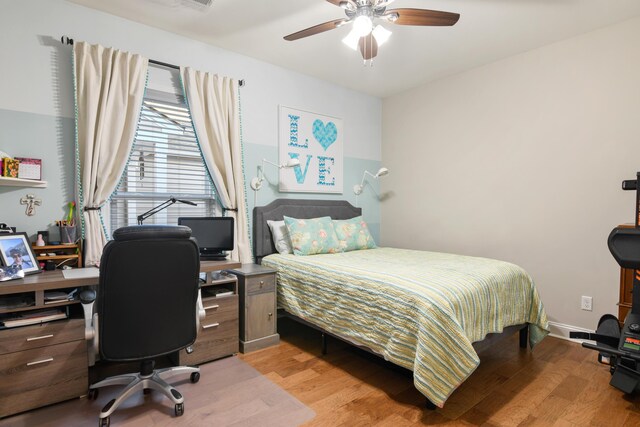 bedroom with ceiling fan and light hardwood / wood-style floors