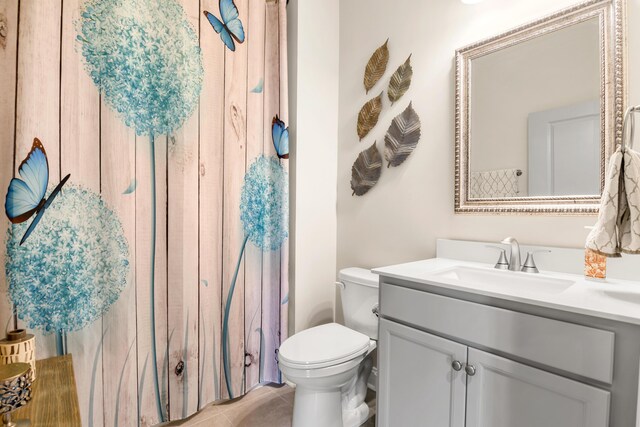 bathroom featuring tile patterned floors, vanity, and toilet