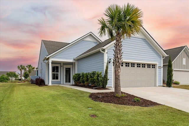 view of front of home with a garage and a yard