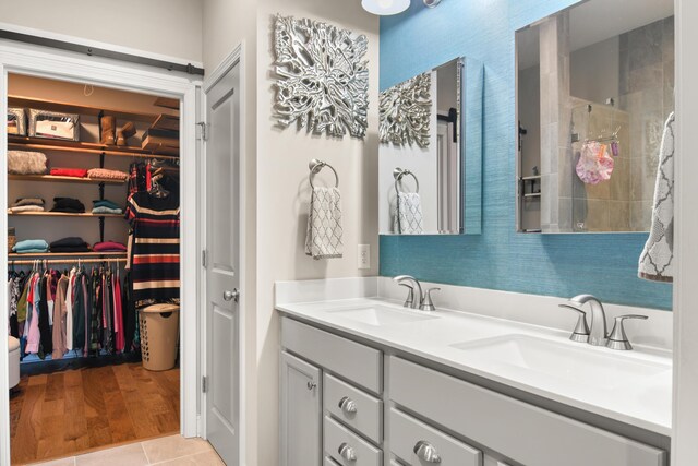 bathroom featuring tile patterned floors, vanity, and tiled shower