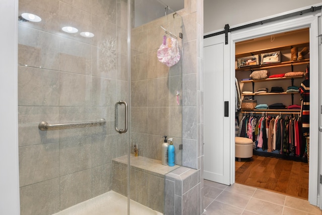 bathroom with tile patterned flooring and a shower with shower door