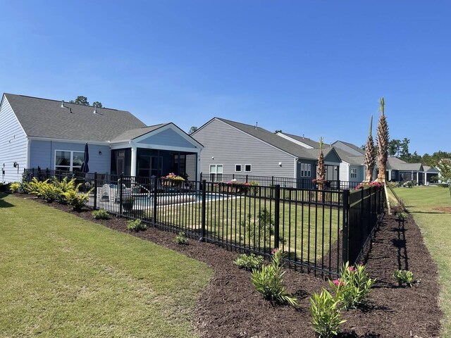 view of yard with a fenced in pool, a sunroom, and a patio