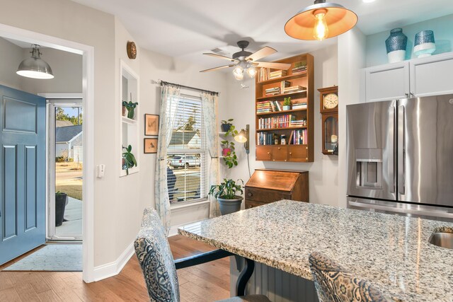 dining space featuring ceiling fan, a healthy amount of sunlight, and light hardwood / wood-style flooring