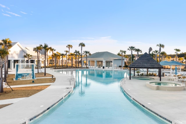 view of swimming pool with a gazebo, a patio area, and a community hot tub