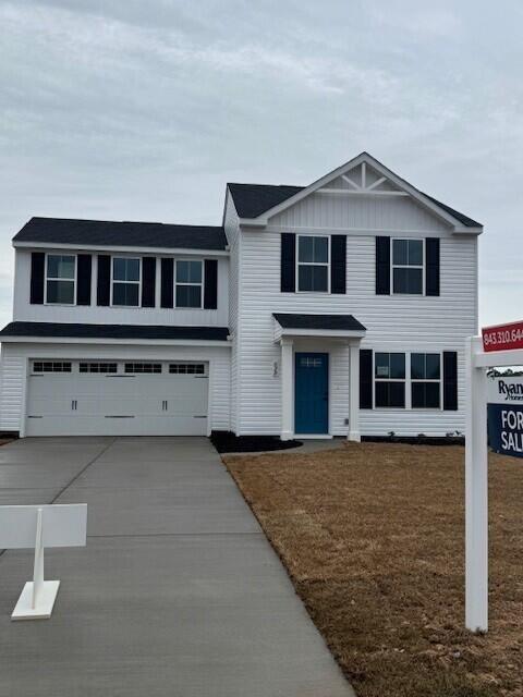 view of front of house with a garage and a front yard