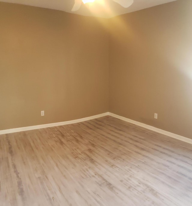 unfurnished room with hardwood / wood-style flooring