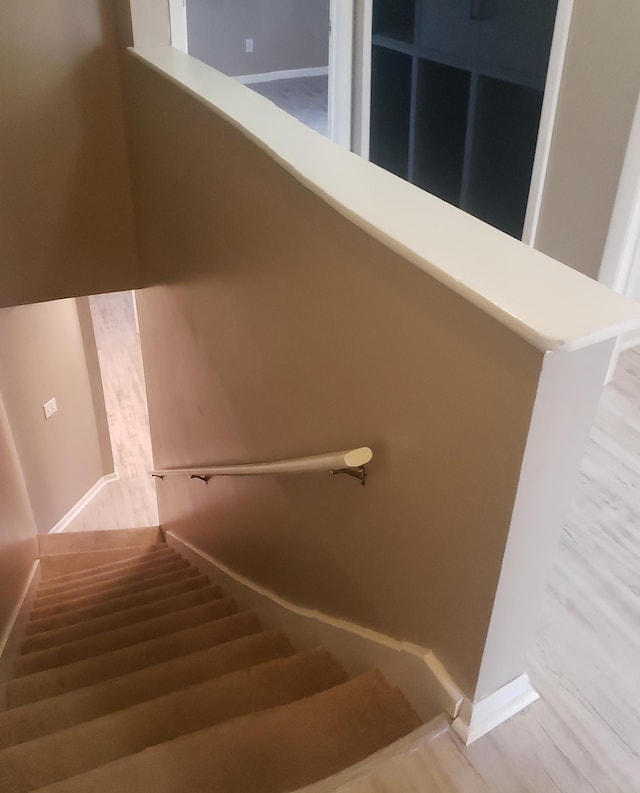 stairs with wood-type flooring