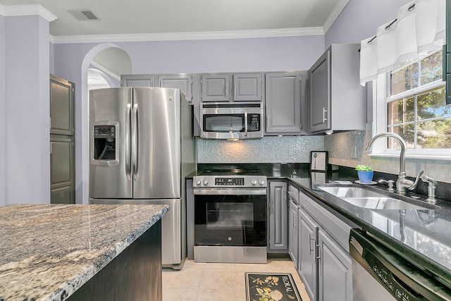 3257 Heathland Way, Mount Pleasant, SC 29466 - kitchen featuring stainless steel appliances, gray cabinets, crown molding, backsplash, and light tile patterned floors