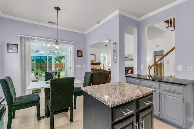 3257 Heathland Way, Mount Pleasant, SC 29466 - kitchen featuring a kitchen island, crown molding, pendant lighting, light tile patterned flooring, and open floor plan