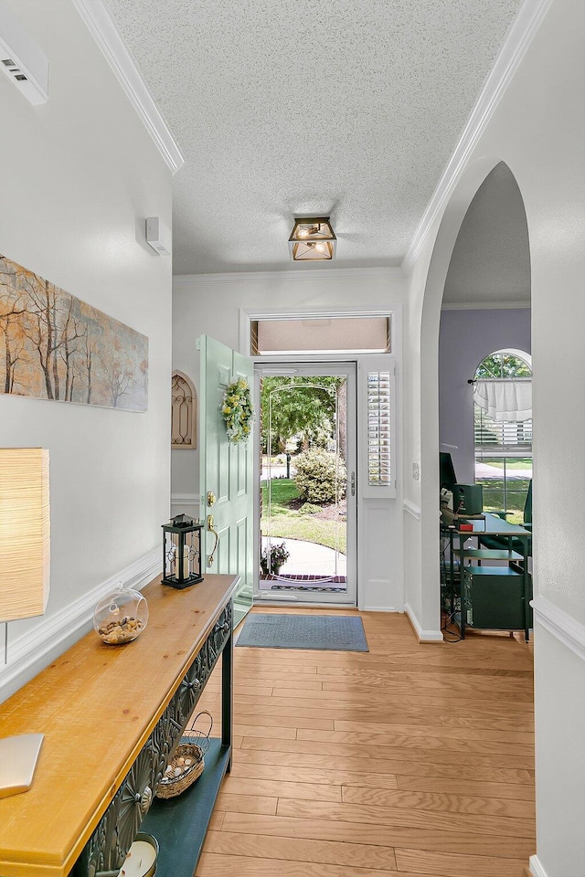 3257 Heathland Way, Mount Pleasant, SC 29466 - entrance foyer featuring crown molding, a textured ceiling, wood finished floors, and arched walkways