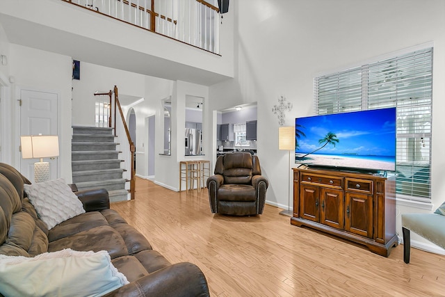 3257 Heathland Way, Mount Pleasant, SC 29466 - living area featuring a towering ceiling, light wood-style floors, and stairs