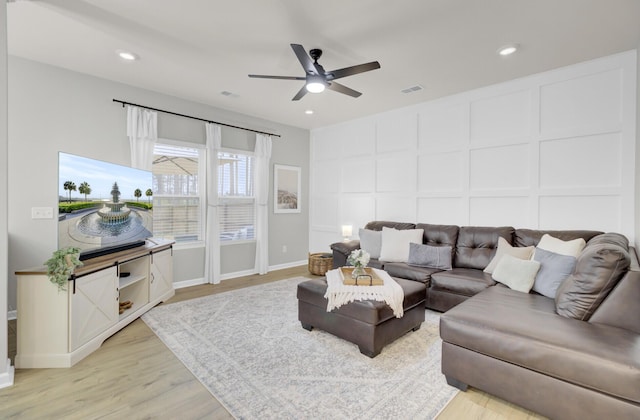 living room with ceiling fan and light wood-type flooring