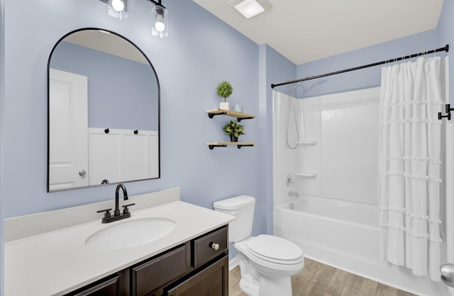 full bathroom with vanity, hardwood / wood-style floors, shower / tub combo, and toilet