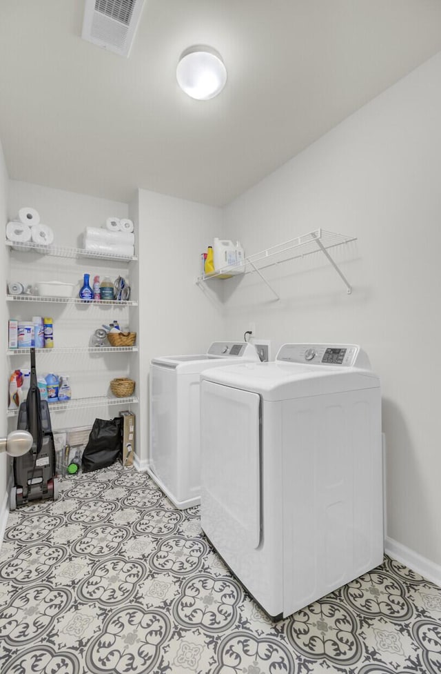 laundry area with light tile patterned floors and independent washer and dryer