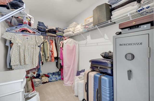 walk in closet with carpet