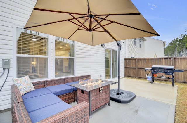 view of patio / terrace featuring area for grilling and an outdoor living space with a fire pit