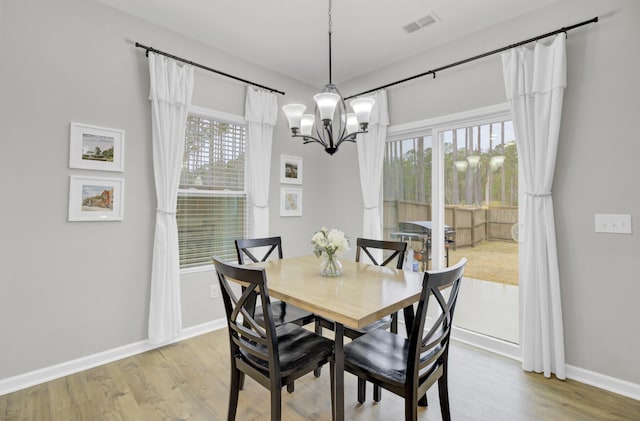 dining area featuring a chandelier and light hardwood / wood-style floors