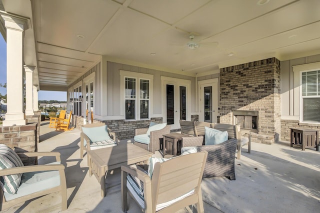 view of patio / terrace featuring an outdoor living space with a fireplace and ceiling fan