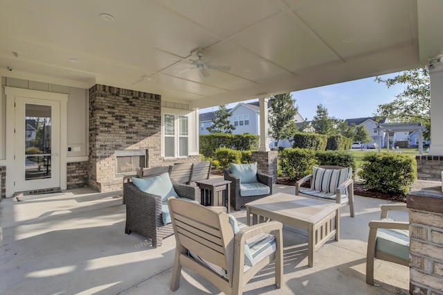 view of patio featuring an outdoor living space with a fireplace and ceiling fan