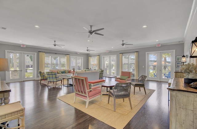 living room featuring crown molding, dark wood-type flooring, and french doors