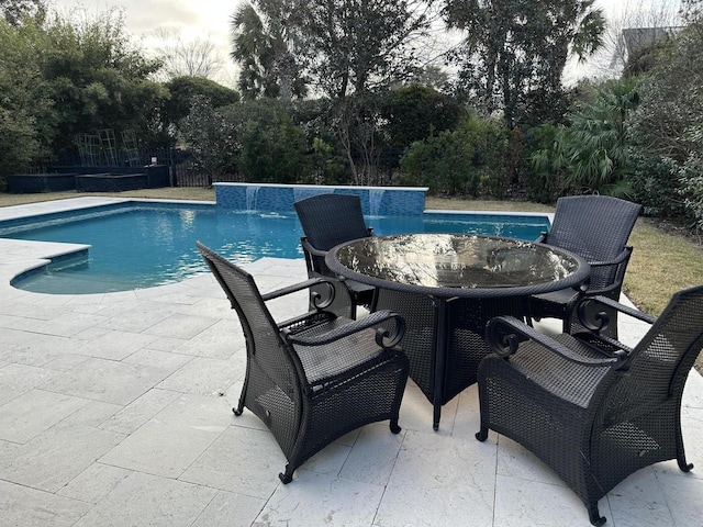 view of swimming pool featuring pool water feature and a patio area