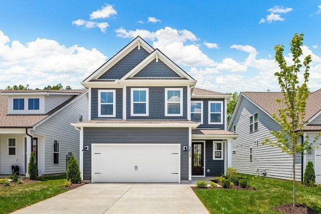 view of front of property featuring a front lawn, an attached garage, and driveway