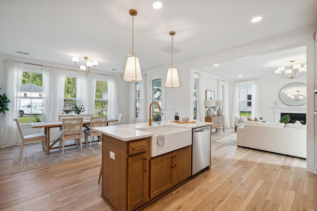 kitchen with a chandelier, dishwasher, brown cabinets, light wood-style flooring, and a sink