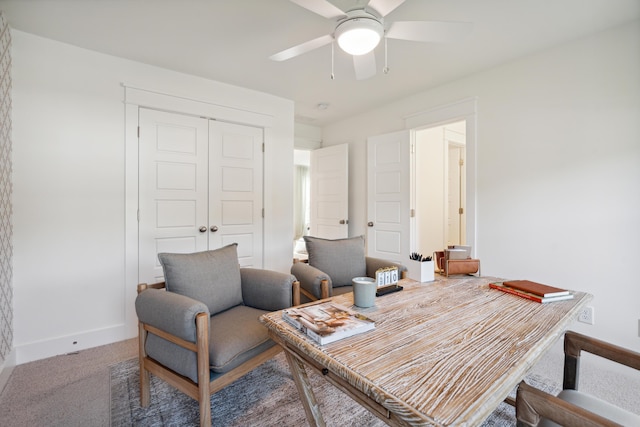 office space with baseboards, carpet, and a ceiling fan