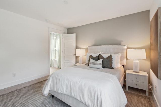 carpeted bedroom featuring baseboards