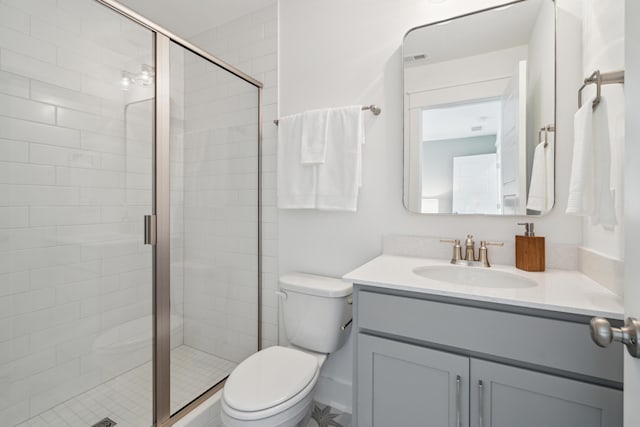 full bathroom featuring visible vents, toilet, a shower stall, and vanity