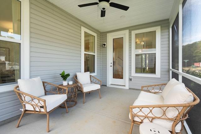 sunroom / solarium with a ceiling fan