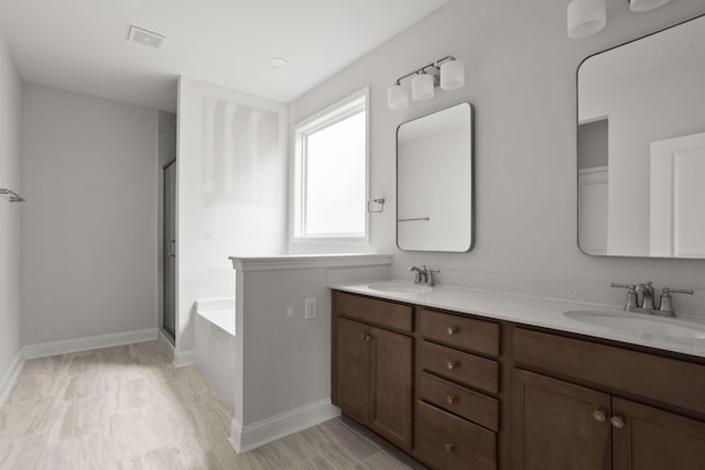 bathroom featuring separate shower and tub and vanity