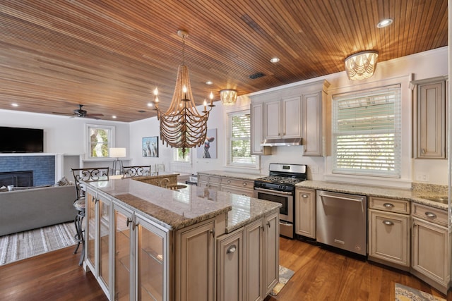 2218 Myrtle Ave, Sullivans Island, SC 29482 - kitchen with stainless steel appliances, wooden ceiling, a chandelier, a center island with sink, and a fireplace