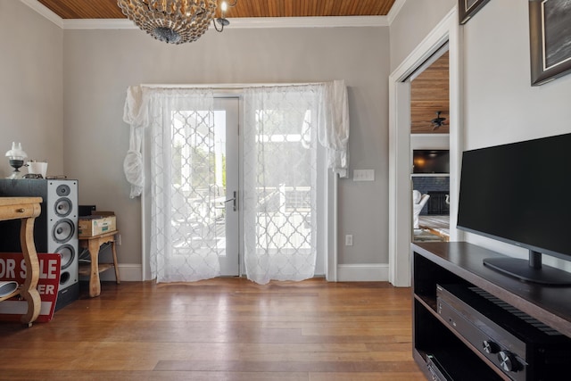 2218 Myrtle Ave, Sullivans Island, SC 29482 - doorway to outside with crown molding, hardwood / wood-style floors, a chandelier, and wood ceiling