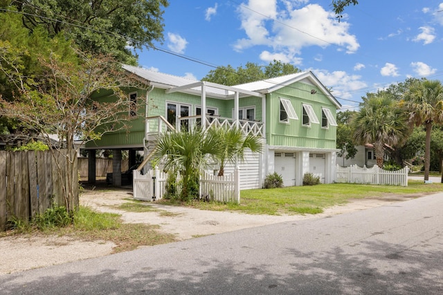 2218 Myrtle Ave, Sullivans Island, SC 29482 - coastal inspired home featuring dirt driveway, an attached garage, a metal roof, and stairway