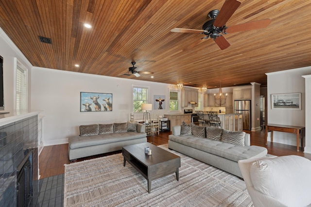 2218 Myrtle Ave, Sullivans Island, SC 29482 - living room with wooden ceiling, a ceiling fan, a tiled fireplace, wood finished floors, and a chandelier